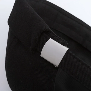Minimalist black brimless cap showing adjustable silver metal buckle and premium stitching
