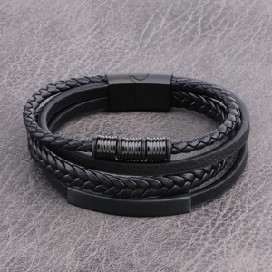 Detail of multi-layer black braided leather bracelet with matte metal magnetic clasp