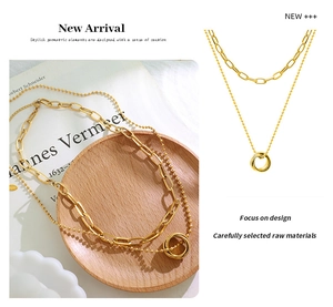 Detail of 18K gold plated double layer necklace with interlocked rings and paperclip chain