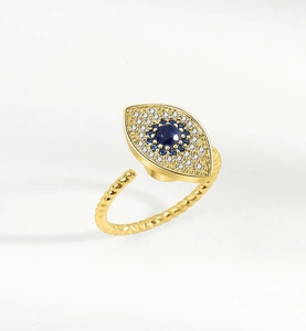 Close-up of golden evil eye spinner ring with blue and white zircons and rope band