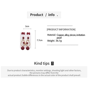 Detail view of 6-piece earring set with red bows and faux pearls on measurement card