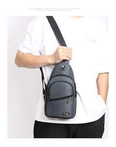 Detail of grey water-resistant oxford fabric sling bag with multiple zipper pockets