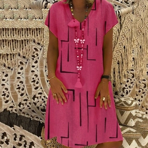 Pink V-neck short sleeve dress with black geometric lines and fringe necklace