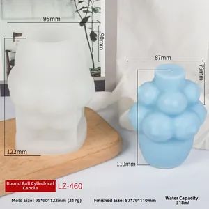 Detail view of spherical bubble silicone mold beside finished light blue candle product