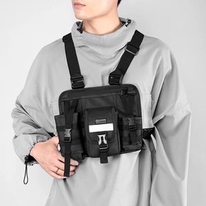 Close-up of black tactical chest rig with MOLLE system and adjustable buckles for outdoors