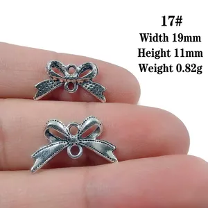 Detailed view of silver bow-shaped connectors for jewelry DIY showing exact dimensions