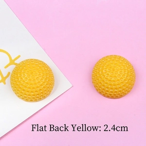 Macro view of 2.4cm yellow resin golf-textured flatback charms for DIY crafts
