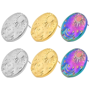 Detail of oval stainless steel stud earrings with sun moon and star celestial motifs