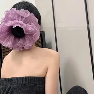 Elegant purple pleated scrunchie hair tie shown on a bun for a voluminous ruffled look