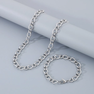 Close-up of silver stainless steel jewelry set with woven chain texture and lobster clasp