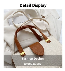 Close-up of beige lychee grain tote bag with dark brown handles and gold hardware accents