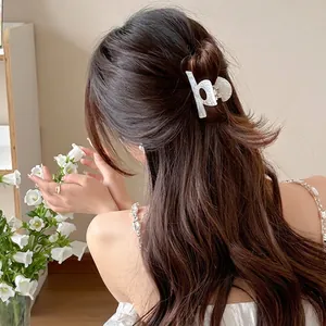 Elegant white marble acetate hair claw clip with geometric hollow design for women