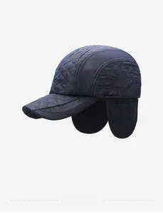 Detail view of navy blue quilted earflap baseball cap with warm lining and embroidery