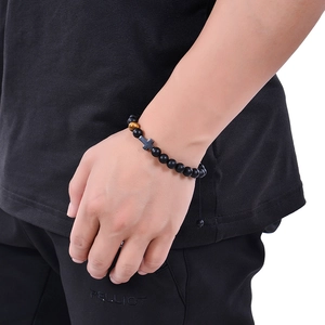 8MM natural matte stone beaded bracelet with cross charm on male model's wrist