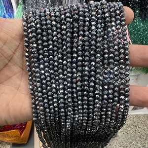 Macro detail of faceted Terahertz energy beads for DIY jewelry making in dark grey