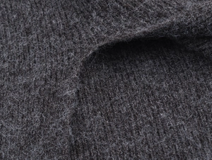 Close-up of deep charcoal knit fabric texture with thick woolly feel for thermal warmth