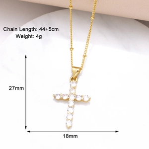 Detail view of gold cross pendant with cubic zirconia inlay and size dimensions