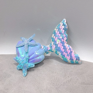 Detail of sequined mermaid tail hair clip with holographic shells and starfish accents