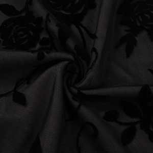 Detailed macro view of black flocked rose patterns on translucent mesh fabric textures