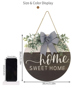 Macro detail of 30cm wooden Home Sweet Home door wreath with eucalyptus and striped bow
