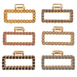 Detailed grid of large alloy claw clips with colorful marble resin patterns