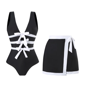 Detail of V-neck one-piece swimsuit with white bows and matching wrap skirt set