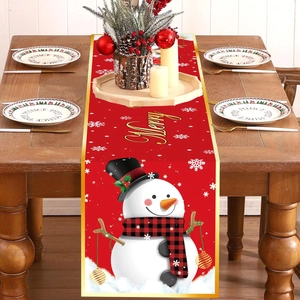 Christmas table runner with snowman and snowflakes on a festive wooden dining table setup