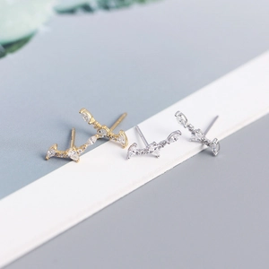 Macro shot of silver and gold bar earrings with marquise-cut cubic zirconia crystals