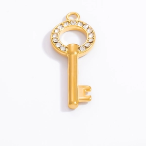 Macro detail of 18k gold plated key pendant with sparkling round pavé zirconia stones
