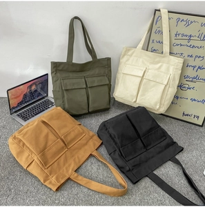 Canvas tote bag in army green, cream, yellow, and black showcasing large capacity