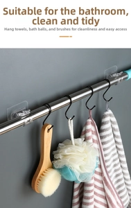 Adhesive curtain rod bracket holder with stainless steel finish and black S-hooks in bathroom