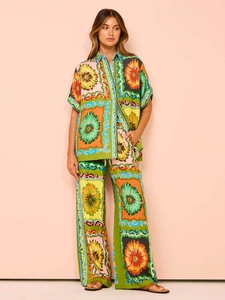 Women summer set featuring floral sunflower print shirt and wide-leg pants on model