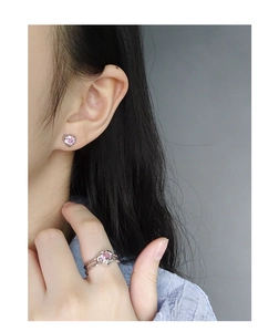 Close-up of minimalist S925 silver set with pink heart-shaped zircon earrings and ring
