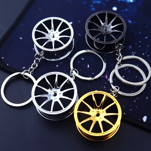 Detailed view of alloy car wheel rim keychains in silver, black and gold metallic finishes