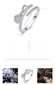 Detailed view of silver-tone bow ring featuring 29 inset zircons and adjustable band width