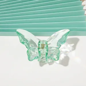 Detail of green butterfly hair claw clip with crystal texture and caustic shadows