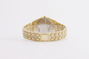Macro shot of gold-plated octagonal watch band with pavé set rhinestones details