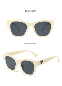 Detail of beige oversized square sunglasses featuring a golden heart detail on the temple.