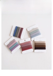 Detail of colorful elastic fabric hair ties organized on white card displays