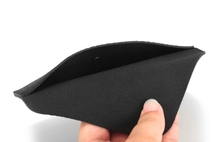 Internal view of the black textured glasses case showing thickness and protective lining