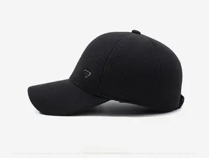 Close-up of black knitted baseball cap featuring side triangular metal logo detail
