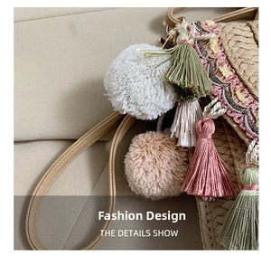 Detail of bohemian straw bag with colorful tassels, fluffy pom-poms and leather strap
