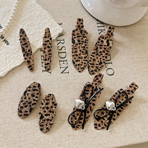 Set of 8 vintage leopard print hair clips including bow and oval styles for women
