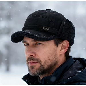 Detail of black winter trapper hat with warm faux shearling lining and metal sports logo