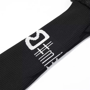 Detailed close-up of black knitted golf headcover with faux fur trim and C#m lettering