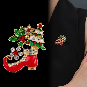 Creative Christmas boot brooch with tree and rhinestones shown on model and black background