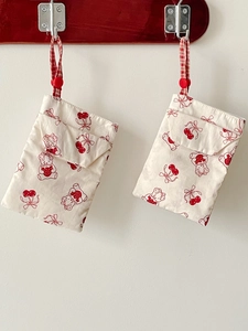 Hanging fabric pouches with cartoon bear and cherry prints, featuring red checkered straps