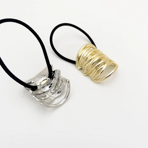 Minimalist gold and silver metallic hair ties with hollow layered wrap design for ponytails