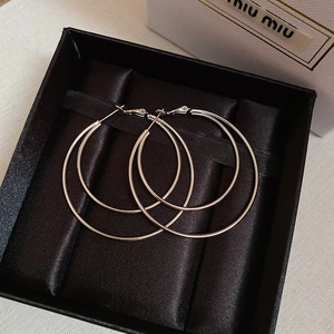 Double-layered silver hoops displayed in a premium black satin-lined jewelry box