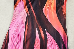 Close-up of abstract colorful print fabric with pink and brown flowing stripe patterns